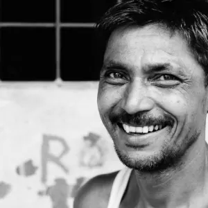 Man with stubble raising smile