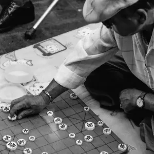 older man playing Korean chess