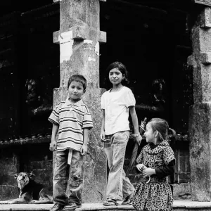 Children and a dog in front of Machhindranath Temple