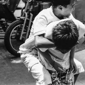 Boy holding onto boy tightly
