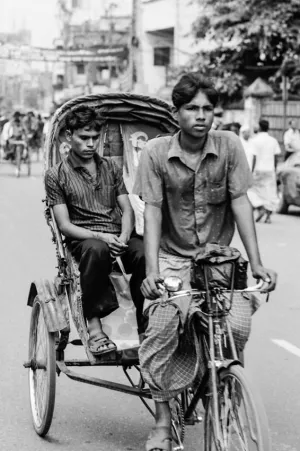 Rickshaw wallah pedaling cycle rickshaw