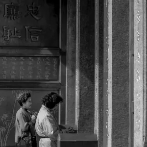 Women standing in front of door in Hsing Tian Kong Temple