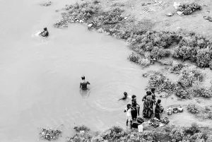 People standing in armlet of Mahananda river