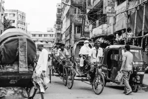 Cycle rickshaw with passenger running