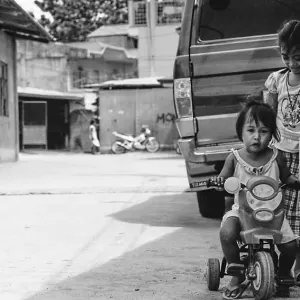 Little girl riding tricycle
