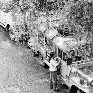 Woman standing by jeepney