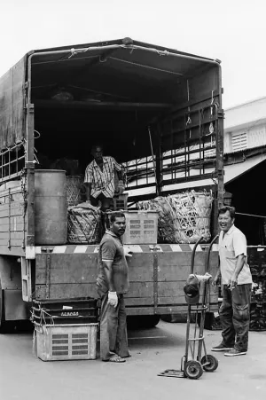 Men delivering goods in market