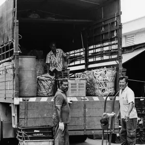 Men delivering goods in market