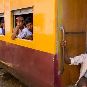 Two men by car window of a train