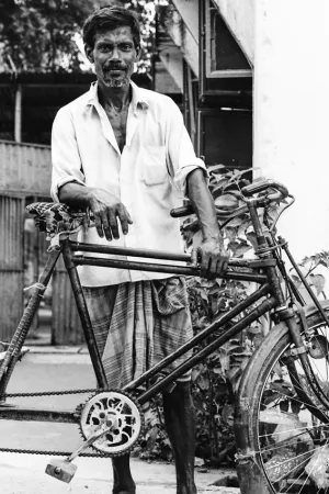 Man standing beside cycle rickshaw