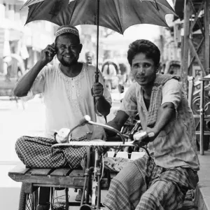 Two men on tricycle