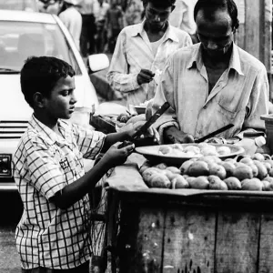 Men selling fruits by roadside