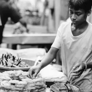 Young man selling sweets called Jalebi