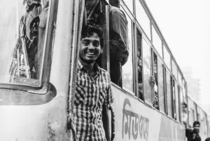 Bus conductor standing at platform