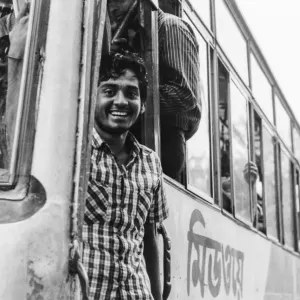 Bus conductor standing at platform