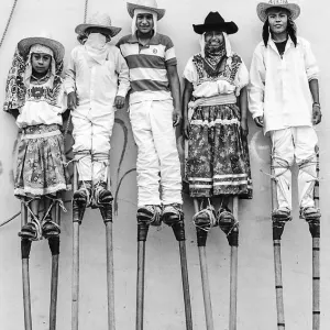 Boys wearing tall stilts