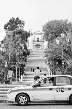 Cab parked at the bottom of the stairs leading to the church