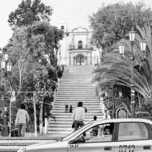 Cab parked at the bottom of the stairs leading to the church