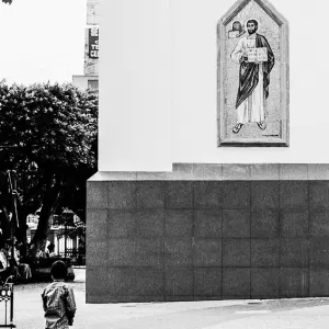 Boy standing in front of saint