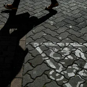 Traffic sign and legs of woman