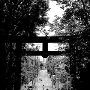 Silhouetted woman on other side of Torii