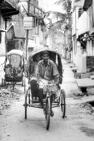 Cycle rickshaw running dirt road