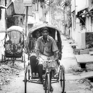 Cycle rickshaw running dirt road