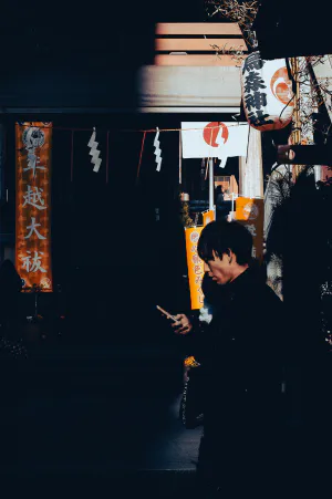 Young man walking in front of a shrine