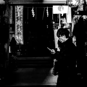 Young man walking in front of a shrine