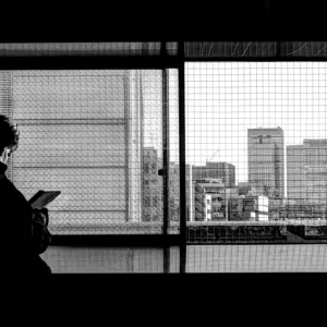 Silhouetted man by window