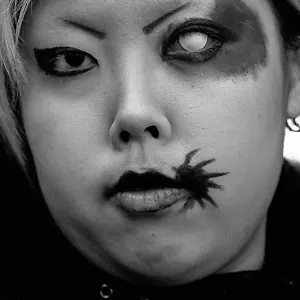 girl with enigmatic sign beside her lips