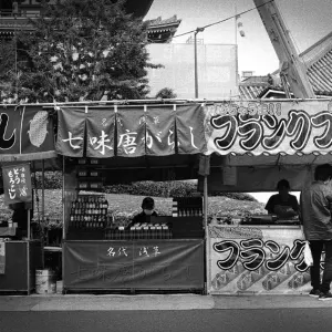 Young couple standing in front of food stall